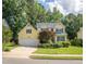 Charming two-story home with a well-manicured lawn, complemented by colorful flower beds and lush greenery at 5417 Harrington Grove Dr, Raleigh, NC 27613
