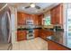 This kitchen features stainless steel appliances, granite countertops, and ample wood cabinetry at 5417 Harrington Grove Dr, Raleigh, NC 27613
