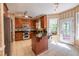 Well-equipped kitchen featuring stainless steel appliances, a central island, and tiled floors at 5417 Harrington Grove Dr, Raleigh, NC 27613