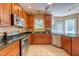 Kitchen showcases a stainless steel oven and dishwasher, alongside wood cabinets and granite counters at 5417 Harrington Grove Dr, Raleigh, NC 27613