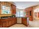 Kitchen with granite countertops, stainless steel dishwasher, wood cabinets and tiled floor at 5417 Harrington Grove Dr, Raleigh, NC 27613