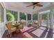 Relaxing screened porch featuring wicker furniture, a glass-top table and a stained glass door at 5417 Harrington Grove Dr, Raleigh, NC 27613