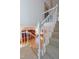 Carpeted staircase with white railing overlooking the hardwood floors of the living room at 5417 Harrington Grove Dr, Raleigh, NC 27613