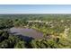 Breathtaking aerial view of a tranquil lake surrounded by lush forests and a distant cityscape at 5812 N Beaver Ln, Raleigh, NC 27604
