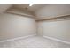 Unfinished attic room with built in shelves and carpet at 5812 N Beaver Ln, Raleigh, NC 27604