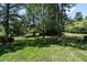 Private backyard featuring a lush green lawn and mature shade trees at 5812 N Beaver Ln, Raleigh, NC 27604