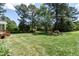 Lush backyard featuring mature landscaping and manicured lawn at 5812 N Beaver Ln, Raleigh, NC 27604