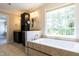 Spa-like bathroom with a soaking tub and double vanity at 5812 N Beaver Ln, Raleigh, NC 27604