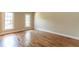 Bright bedroom with hardwood floors, two windows and neutral paint, providing a serene atmosphere at 5812 N Beaver Ln, Raleigh, NC 27604