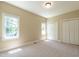 Bedroom with carpeted floor, double windows and closet at 5812 N Beaver Ln, Raleigh, NC 27604