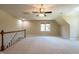 Upstairs bonus room offering neutral paint, plush carpet and a ceiling fan at 5812 N Beaver Ln, Raleigh, NC 27604