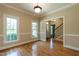 Well lit empty room featuring hardwood floors, neutral walls and molding and window views at 5812 N Beaver Ln, Raleigh, NC 27604