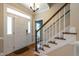 Bright foyer with wood floors, a staircase, and sidelights, creates a welcoming entrance at 5812 N Beaver Ln, Raleigh, NC 27604