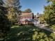 Charming two-story home boasts red shutters, a well-manicured lawn, and mature trees at 5812 N Beaver Ln, Raleigh, NC 27604
