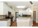 Bright kitchen with stainless appliances, granite counters, and tiled backsplash at 5812 N Beaver Ln, Raleigh, NC 27604