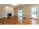 Spacious living room with hardwood floors, fireplace, and sliding doors to screened porch at 5812 N Beaver Ln, Raleigh, NC 27604