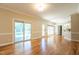 Open floor plan with hardwood floors, sliding doors to porch, and access to breakfast bar at 5812 N Beaver Ln, Raleigh, NC 27604
