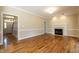 Light filled living room with hardwood floors, fireplace, and easy access to the entry foyer at 5812 N Beaver Ln, Raleigh, NC 27604