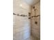 Close-up of a shower with tile walls and an adjustable shower head at 5812 N Beaver Ln, Raleigh, NC 27604
