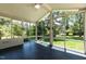 Enclosed sunroom offering walls of windows, black tile floor and a ceiling fan at 5812 N Beaver Ln, Raleigh, NC 27604