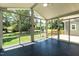 Enclosed sunroom features large windows, tiled floor and ceiling fan at 5812 N Beaver Ln, Raleigh, NC 27604