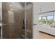 Modern bathroom with a glass-enclosed shower and natural light from bedroom windows at 618 N Boylan Ave # 810, Raleigh, NC 27603