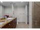 Bathroom with double sinks, granite countertops, and a separate shower enclosure at 618 N Boylan Ave # 810, Raleigh, NC 27603