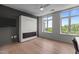 Bright, airy bedroom features large windows with tree views, light hardwood floors and a wall-mounted television at 618 N Boylan Ave # 810, Raleigh, NC 27603