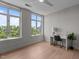 Bright bedroom with great natural light featuring large windows, hardwood floors, a desk, and a ceiling fan at 618 N Boylan Ave # 810, Raleigh, NC 27603