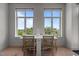 Dining area with large windows offering a view to lush trees and neighborhood at 618 N Boylan Ave # 810, Raleigh, NC 27603