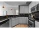 Well-lit kitchen boasts granite countertops, stainless steel appliances, light grey cabinetry and hardwood floors at 618 N Boylan Ave # 810, Raleigh, NC 27603
