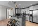 Modern kitchen with grey cabinets, bar seating, granite countertops, and stainless appliances at 618 N Boylan Ave # 810, Raleigh, NC 27603