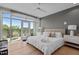 Stylish primary bedroom offers balcony access, hardwood floors, large windows and ensuite bathroom at 618 N Boylan Ave # 810, Raleigh, NC 27603