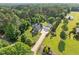 An aerial view of a gray home with a two-car garage and long driveway on a large lot at 6200 Oliver Creek Pkwy, Holly Springs, NC 27540