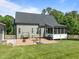 Backyard features a brick patio, screened porch, and well-manicured lawn at 6200 Oliver Creek Pkwy, Holly Springs, NC 27540