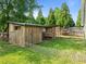 Fenced backyard featuring a wooden structure, providing a designated area for pets and outdoor hobbies at 6200 Oliver Creek Pkwy, Holly Springs, NC 27540