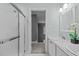 Well-lit bathroom with double vanity, framed mirror, and a glass-enclosed shower at 6200 Oliver Creek Pkwy, Holly Springs, NC 27540