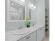 Bright bathroom featuring double sinks, marble countertop, white cabinets and framed mirrors at 6200 Oliver Creek Pkwy, Holly Springs, NC 27540