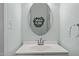 Clean and modern bathroom with a vanity, oval mirror, and sleek fixtures at 6200 Oliver Creek Pkwy, Holly Springs, NC 27540