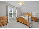 Comfortable bedroom features a wooden bed frame, ceiling fan, and a bright window at 6200 Oliver Creek Pkwy, Holly Springs, NC 27540