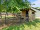Backyard chicken coop, partially fenced, and a rustic wooden structure at 6200 Oliver Creek Pkwy, Holly Springs, NC 27540