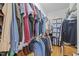 Organized walk-in closet with ample hanging space, shelving, and built-in storage at 6200 Oliver Creek Pkwy, Holly Springs, NC 27540