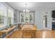 Bright dining area with a modern chandelier and connection to the living room at 6200 Oliver Creek Pkwy, Holly Springs, NC 27540
