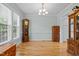 Spacious dining room with large windows, hardwood floors, a decorative clock, and classic charm at 6200 Oliver Creek Pkwy, Holly Springs, NC 27540