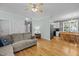 Spacious living room with hardwood floors that opens to the dining area and kitchen at 6200 Oliver Creek Pkwy, Holly Springs, NC 27540