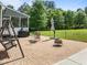 Brick patio with swing, seating, grill and a peaceful backyard view at 6200 Oliver Creek Pkwy, Holly Springs, NC 27540