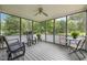 Relaxing screened porch with ceiling fan, comfortable seating, and views of the lush backyard at 6200 Oliver Creek Pkwy, Holly Springs, NC 27540