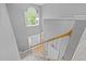 Bright staircase with white railing and a large window providing natural light at 6200 Oliver Creek Pkwy, Holly Springs, NC 27540