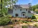 Spacious backyard featuring a wooden deck, lush greenery, and the home's charming exterior at 6420 Dresden Ln, Raleigh, NC 27612