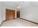 Bedroom featuring neutral color carpet and wood closet doors at 6420 Dresden Ln, Raleigh, NC 27612